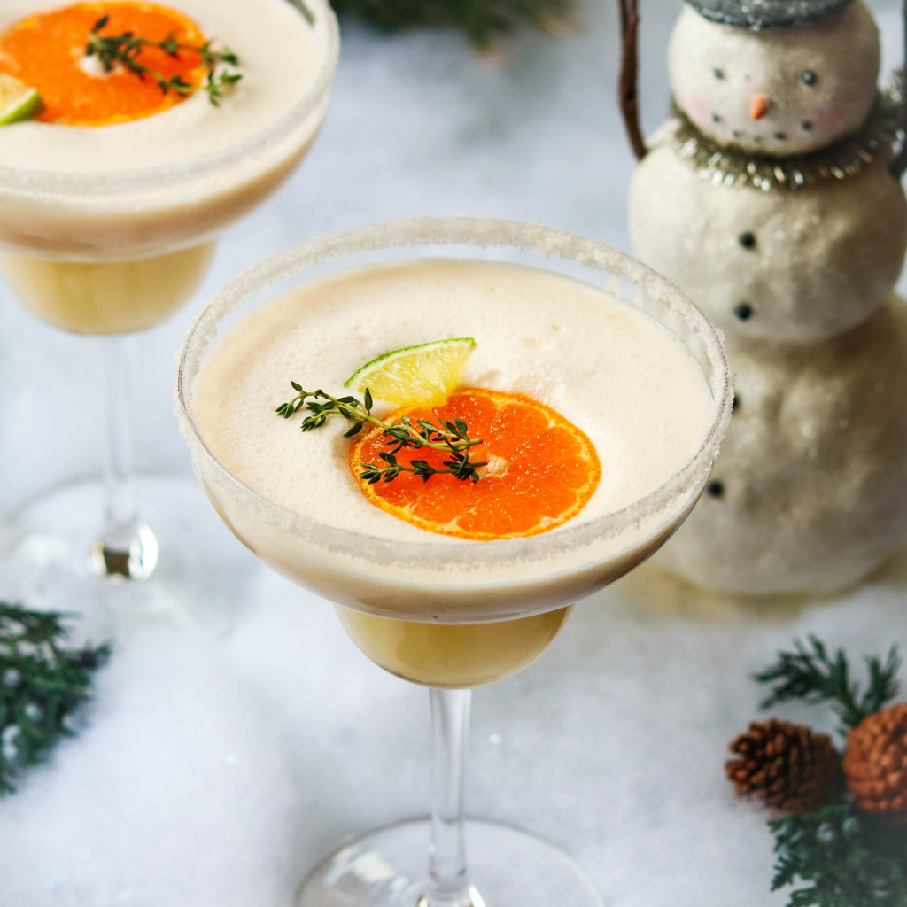 Frosty Citrus & Coconut Margaritas | Give it Some Thyme – a grown up blend of tequila, Grand Marnier, orange and lime juice, coconut milk and ice. A perfect holiday cocktail! #frostymargaritas #citrusmargarita #citrusmargaritarecipe #margaritas #margaritasrecipes #margaritasforacrowd #margaritasandmistletoeparty #christmascocktails #christmascocktailsrecipes #dairyfreecocktails #dairyfreecocktailscoconutmilk #giveitsomethyme
