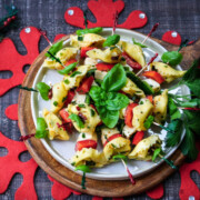 Festive Marinated Tortellini Skewers - Give it Some Thyme – an easy recipe of tortellini, fresh mozzarella and bell peppers marinated in a zesty lemon vinaigrette! #tortelliniskewers #tortelliniskewersappetizers #marinatedtortelliniskewers #pastaappetizers #pastaappetizerseasy #pastaappetizerspartiesfood #christmasappetizers #christmasappetizerseasy #holidayappetizers #holidayappetizerseasy #giveitsomethyme