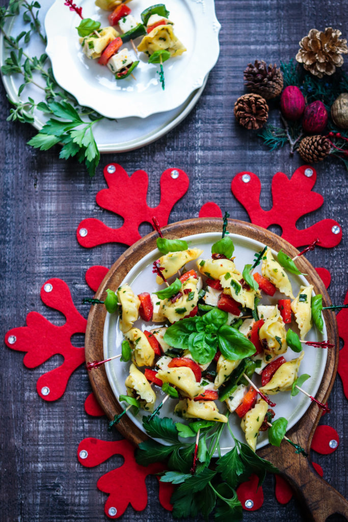 Festive Marinated Tortellini Skewers - giveitsomethyme.com – an easy recipe of tortellini, fresh mozzarella and bell peppers marinated in a zesty lemon vinaigrette! #tortelliniskewers #tortelliniskewersappetizers #marinatedtortelliniskewers #pastaappetizers #pastaappetizerseasy #pastaappetizerspartiesfood #christmasappetizers #christmasappetizerseasy #holidayappetizers #holidayappetizerseasy #giveitsomethyme