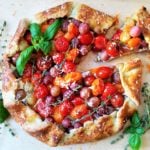 Blistered Cherry Tomato + Grape Galette | Give it Some Thyme – a delicious tomato and grape galette recipe with whipped ricotta and goat cheese all swaddled in a savory herb crust! #tomatogalette #cherrytomatogalette #tomatogaletterecipe #tomatogalettegoatcheese #grapegalette #galette #galetterecipe #galetterecipesavory #galetterecipeeasy #giveitsomethyme