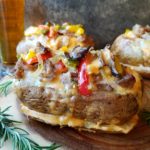 Twice Baked Philly Cheesesteak Potatoes | Give it Some Thyme – twice baked potatoes just rose to another level with this delicious, gluten-free spin on 'one whiz with' - a tasty, hearty, prep-ahead meal served in its own vessel! #bakedpotatoes #loadedbakedpotatoes #twicebakedpotatoes #phillycheesesteak #phillycheesesteakrecipe #phillycheesesteakpotatoes #giveitsomethyme #glutenfreerecipes #glutenfreedinnerideas