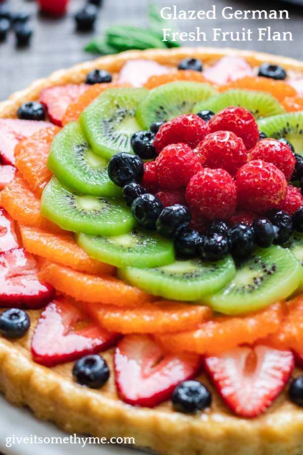 Glazed German Fresh Fruit Flan | Give it Some Thyme – a classic, delicious recipe showcasing beautiful fruit on light, lemon-scented spongecake! #fruitflan #fruitflantart #fruitflanrecipe #germanfruitflan #germanfruitflanrecipe #easterdesserts #springdessertideas #springdessertrecipes #springdesserts #fruitdesserts #fruitdessertrecipes #giveitsomethyme