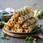 Roasted Chicken Verde Taquitos | giveitsomethyme.com – full of tender rotisserie chicken, bubbling mexican cheese, salsa verde, poblano pepper, green onion, corn, and spices! #taquitos #chickentaquitos #chickentaquitosrecipe #chickentaquitosbaked #easytaquitoschicken #bakedtaquitos #mexicantaquitos #mexicantaquitoschicken #gamedaysnacks #gamedayappetizers #bakedtaquitoschicken #roastedtaquitos #salsaverde #giveitsomethyme