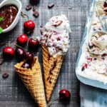No Churn Cherry Vanilla Ice Cream w/ Chocolate Cherry Sauce - no ice cream maker required for this creamy vanilla ice cream loaded with fresh cherries and served with a luscious sauce. #icecream #nochurnicecream #cherryvanillaicecream #frozendesserts #summerdesserts #makeaheaddesserts #giveitsomethyme | giveitsomethyme.com