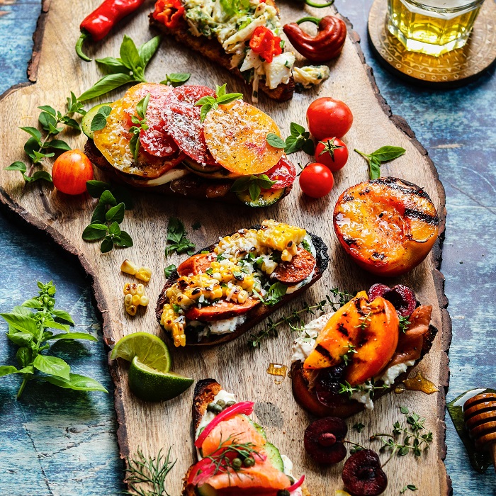 Summer Crostini Five Ways – you’ll love these delicious crostini combos showcasing summer’s bounty! From Top - Lemony Lump Crab, Heirloom Tomato Caprese, Mexican Street Corn & Chorizo, Tuscan Stone Fruit & Prosciutto, and Smoked Salmon & Cucumber Everything Bagel #crostini #summercrostini #appetizers #fingerfoods #fundinners #summerrecipes #giveitsomethyme | giveitsomethyme.com
