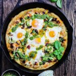 Skillet Breakfast Pesto Pizza – A deep-dish style skillet pizza topped with gooey eggs, creamy jack cheese, chorizo, sun-dried tomatoes, and spinach walnut pesto! #pizza #breakfastpizza #skilletpizza #pizzadough #skilletpizzacastiron #pestopizza #skilletrecipes #breakfast #brunch #gamedayfood #giveitsomethyme | giveitsomethyme.com