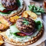 Grilled Greek minted lamb burgers served on pitas with tzatziki, lettuce, red onion and tomato.