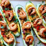 Hollowed zucchini filled with paella and topped with shrimp and chorizo.