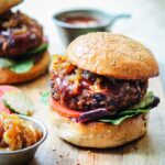 Southwest black bean burgers served on multi-grain bun topped with bbq sauce, caramelized onions, lettuce and tomato.
